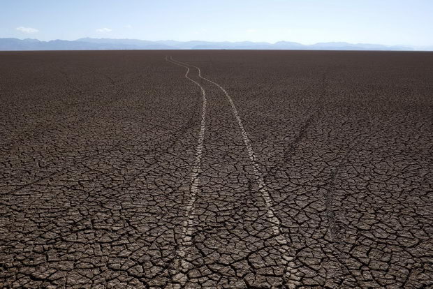 Marks of car tires are seen on the dried Poopo lakebed in the Oruro Department, south of La Paz, Bolivia