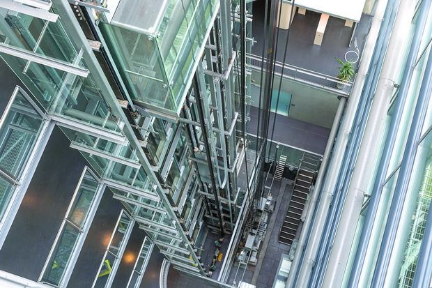 Looking downwards in a modern open elevator shaft