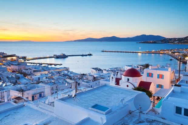 View of Mykonos town and Tinos island in the distance, Greece.